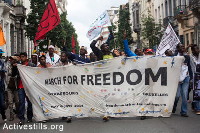 Activists carry a banner during the final day of the March for Freedom